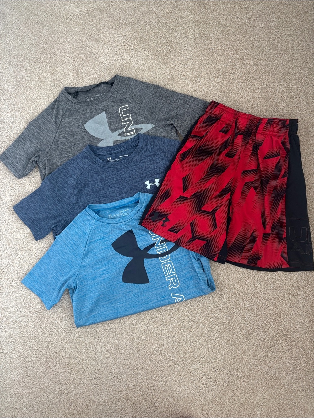 Boys’ Under Armour size M bundle - 3 shirts & 1 pair of shorts.